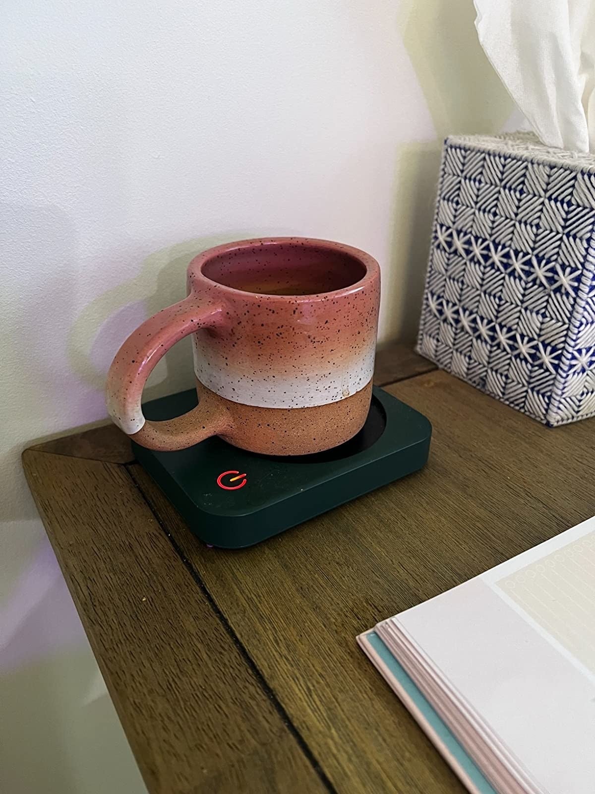 Ceramic mug warming on a black electric mug warmer